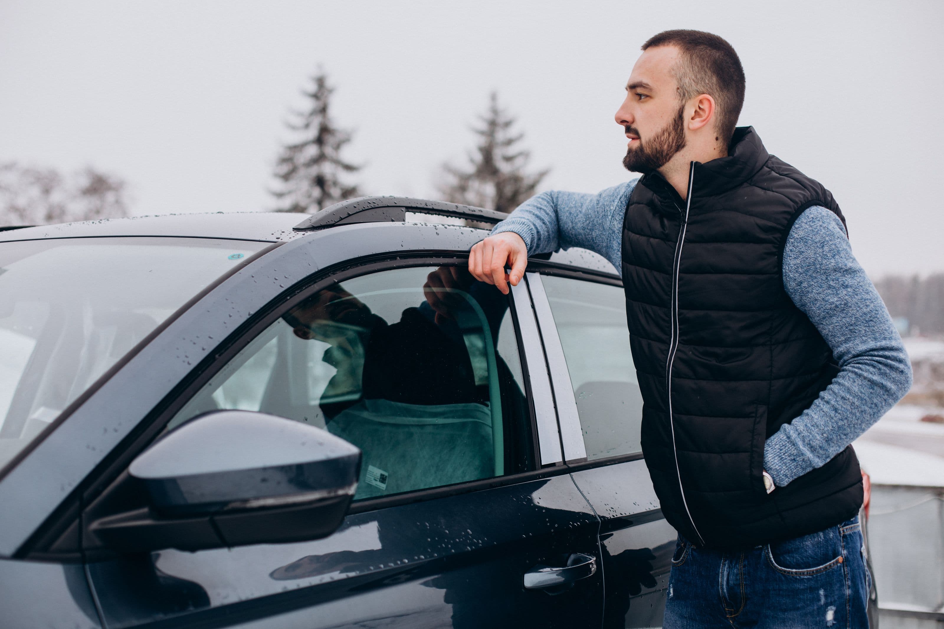 handsome-man-warm-jacket-standing-by-car-covered-with-snow.jpg